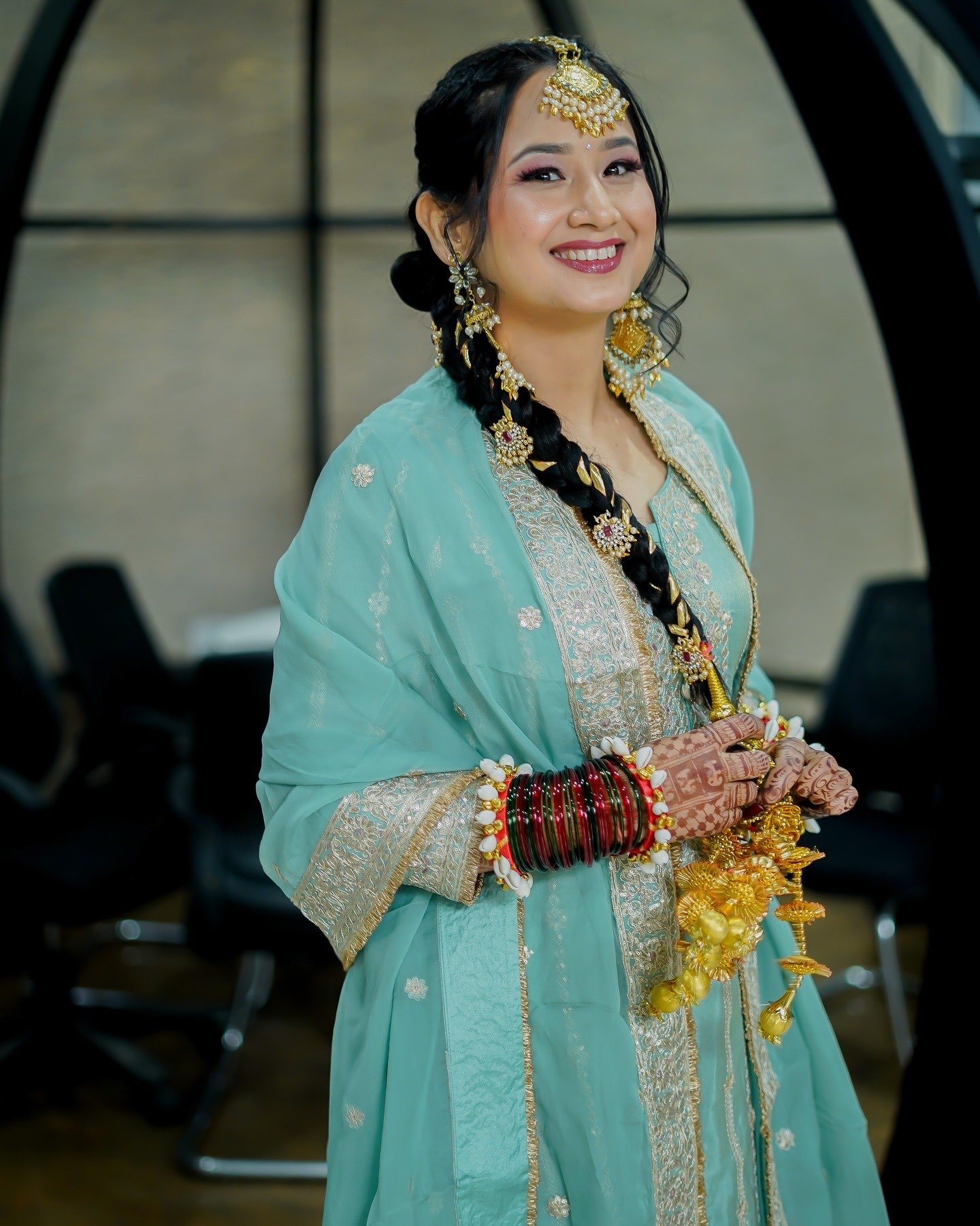 Bride in a mint suit with jasmine-wrapped braid, kaleere and chooda