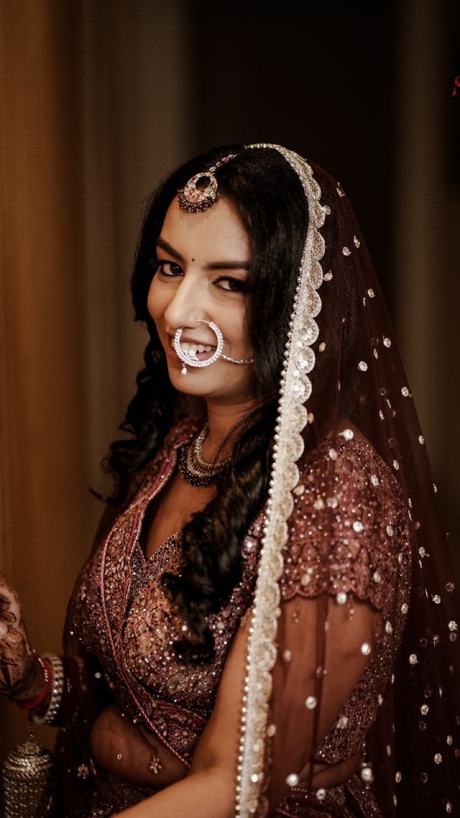 Bride in a maroon lehenga, makeup and styling by Fashion World Palampur